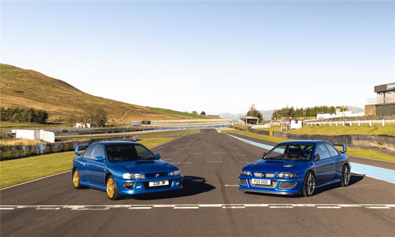 Prodrive P25 and Subaru 22B parked on the main straight at Knockhill Race Circuit